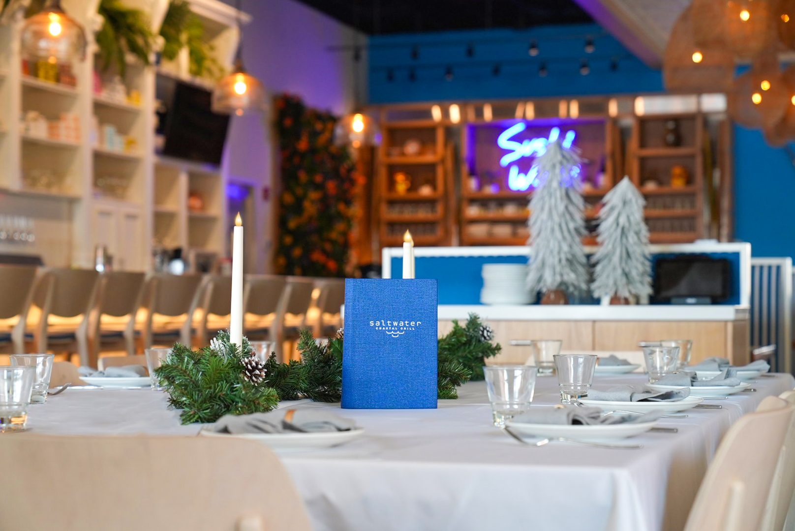 A long holiday dinner table set at Saltwater
